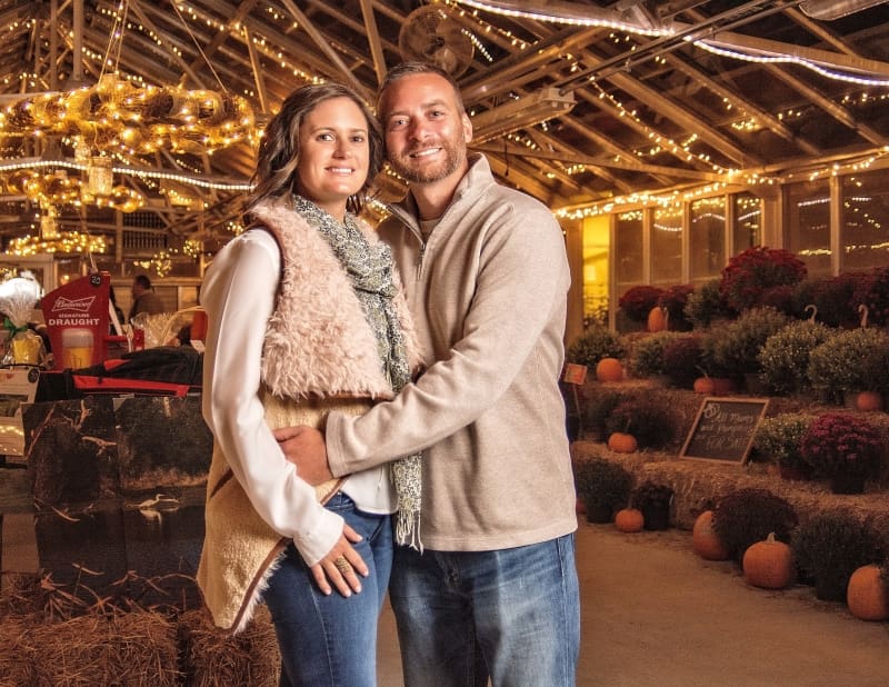 Couple at Providence's 2017 Harvest Bash, surrounded by pumpkins and festive lights.