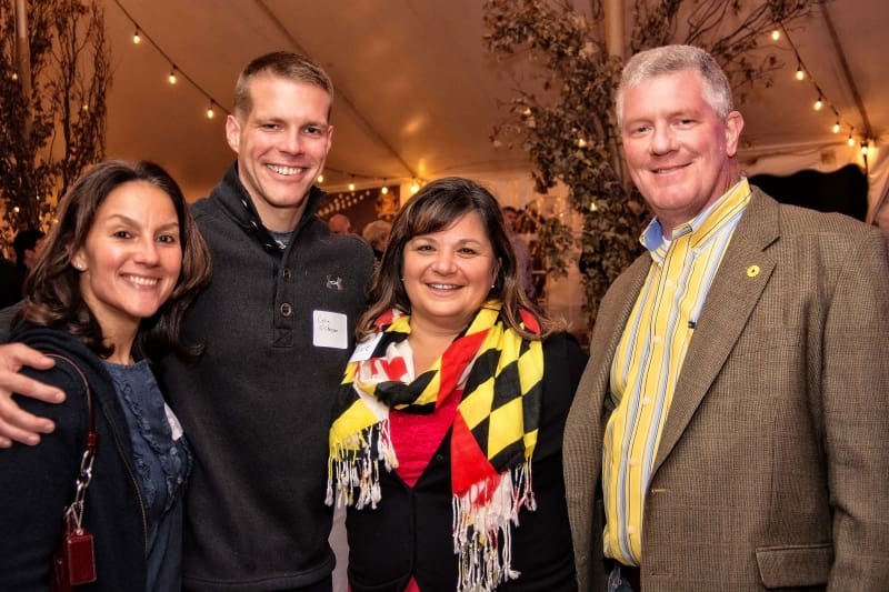 Group of four people at Providence's 2017 Harvest Bash event, smiling for the camera.